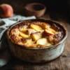 Freshly baked peach bread pudding with golden crust and peach slices